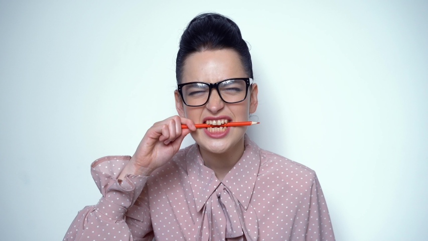 Sexy Brunette Having Pencil In Mouth. Wearing Glasses And Rosy Dress. Having Clear Skin. Natural Beauty Concept.