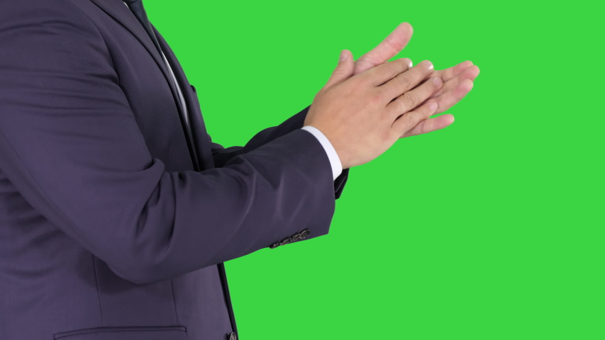 Business man clapping hands on a Green Screen, Chroma Key.