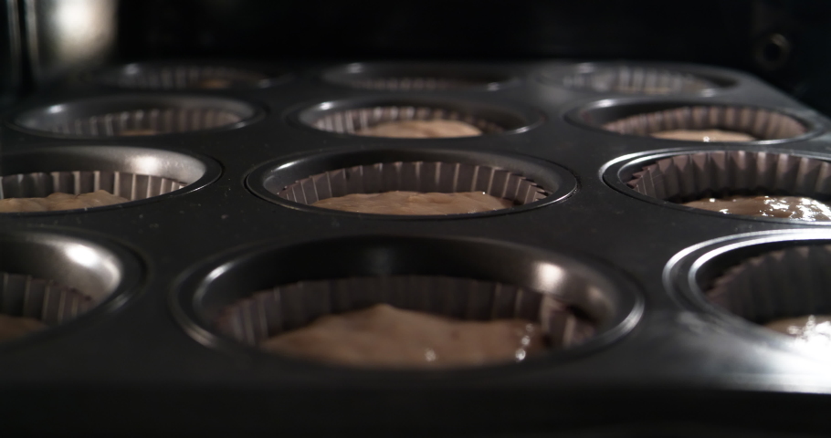 4K - Baking cupcakes in oven. time lapse shot Royalty-Free Stock Footage #1030391354
