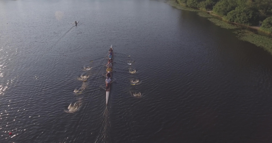 Aerial view of a young team of rowers exercising on the river. Top view of four athletes in a kayak. Training rowers on the river. Sporting Rowing Team Training. Rowing teams compete with each other.  Royalty-Free Stock Footage #1030399433