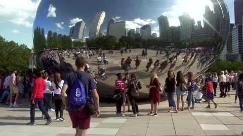Chicago, IL/United States-May 25th 2019: Tourist and local alike are visiting the bean/cloud gate at downtown Chicago millennium park during a nice summer weekend