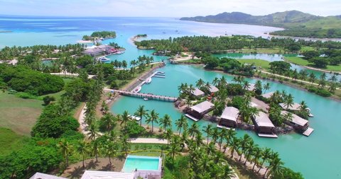 Plantation Island Fiji showing Aerial Footage Resort and Vivid Ocean Colours.