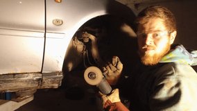 car mechanic with bulgarian tool cuts the metal and repairs a machine - Powered by Shutterstock - Get 15% off with code: PIKWIZARD15