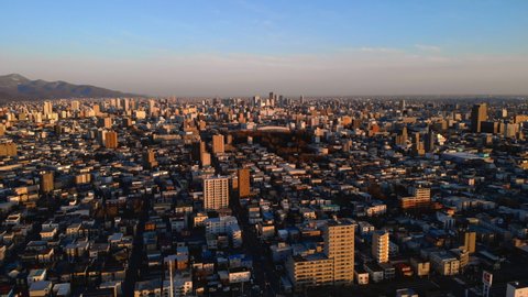 Sapporo city in early morning - Aerial higher altitude ascending view, Hokkaid?, Japan