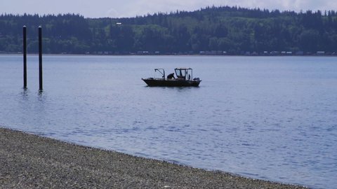 Small, nondescript fishing floating near dock at Camano Island State Park, WA State 10sec/60fps