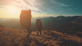 The hikers walking in the mountain on the sunrise background. slow motion - Powered by Shutterstock - Get 15% off with code: PIKWIZARD15