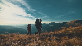 The couple walking on the mountain on a sunny background. slow motion - Powered by Shutterstock - Get 15% off with code: PIKWIZARD15