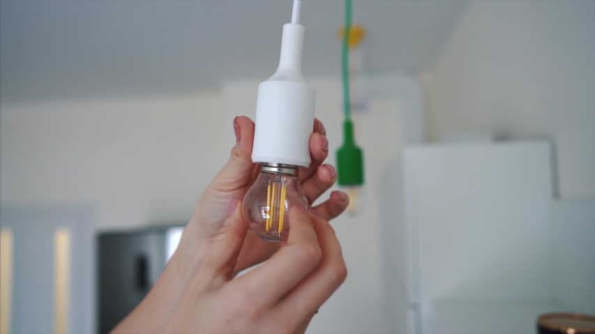 Woman unscrew a light bulb to light does not light