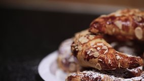 SLOW MOTION Shot of beautiful almond croissants in a plate being powdered with white sugar - 1080p Slide shot from Left to Right at 120fps - Powered by Shutterstock - Get 15% off with code: PIKWIZARD15