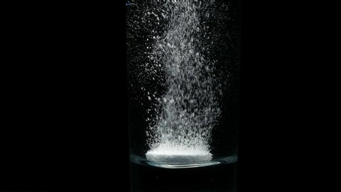 Effervescent tablet dissolving in water. Slow motion. Hull HD