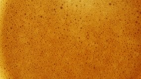4K zooming out macro video of close-up coffee bubbles background, espresso foam, Macro tilt up of espresso coffee poured in a cup and swirling with its cream and aroma. Italian coffee and drink.