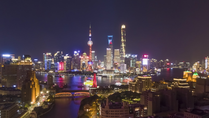 Shanghai City at Night. Urban Lujiazui District, Huangpu River and Waibaidu Bridge. China. Aerial Hyper Lapse, Time Lapse. Drone is Flying Forward and Upward Royalty-Free Stock Footage #1030424807