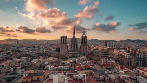 Barcelona - Cathedral, Barri Gothic Quarter, Time lapse. Cumulus sunset clouds over old city districts. Panoramic view, buildings roofs.