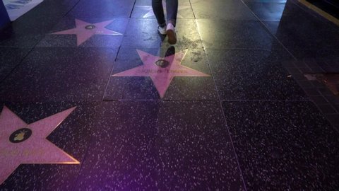 LOS ANGELES, USA - MAY 9, 2019: Woman walking at Walk of Fame at night