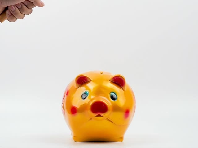 People use the wood hammer smash to the piggy bank on the white background