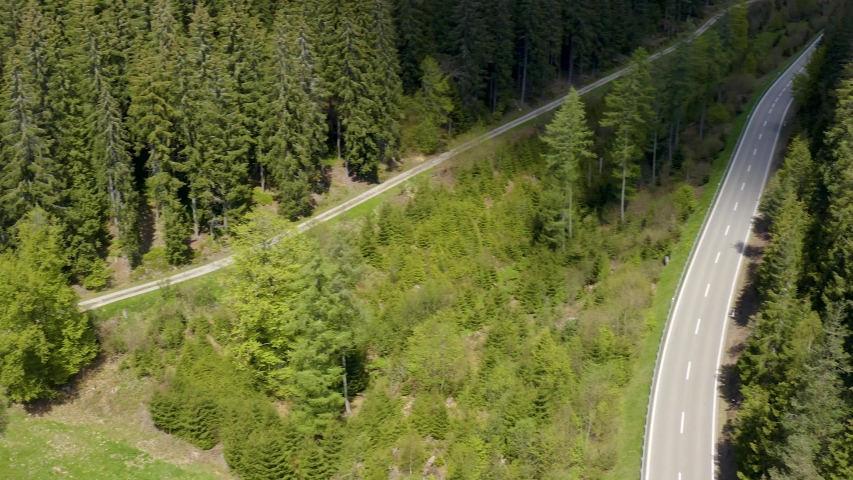 Ascending and zoom out beside a road in the Black forest