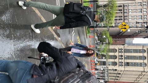 NEW YORK, USA - MAY 5, 2019: Vertical video. Vertical video. Young couple walking and have fun at rain