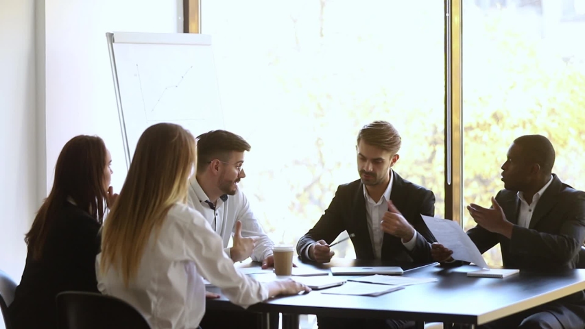Mad african and caucasian colleagues disputing having disagreement at work arguing throwing papers fighting, angry diverse coworkers arguing about bad contract having conflict at workplace concept Royalty-Free Stock Footage #1030504751