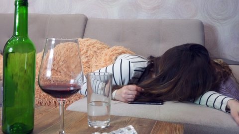 Drunk woman with a headache wakes up after a party, hangover