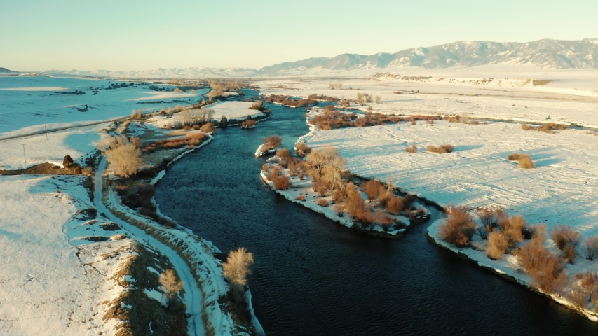 Drone flying above a thawing madison river