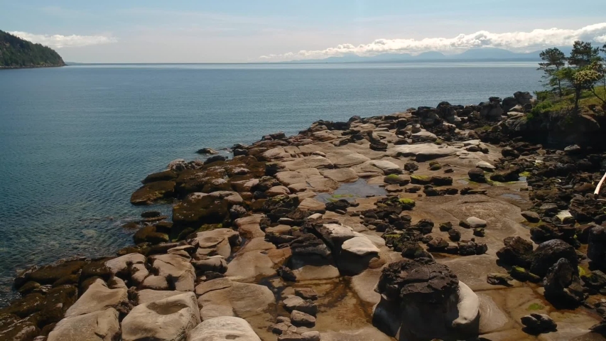 Drone shot of Tribune bay park rock formations with reveal of two people