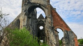 Old ruined church in Zsámbék near to Budapest, Hungary. Springtime, the weather is cloudy. 4K UHD video.