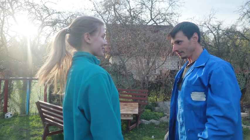Young happy couple rejoice at the work done to make the table from the boards. They hug and whirl.