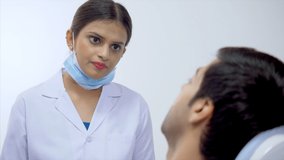 Video of handsome man consulting a female dentist at her clinic - Indian dental clinic.