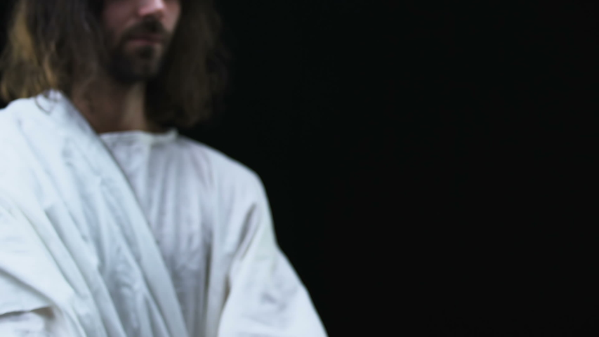 Jesus Christ showing cup of water to camera, helping poor people charity concept