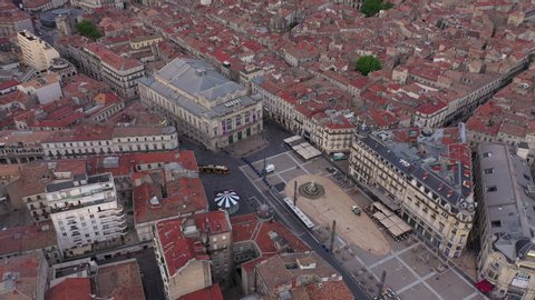 Aerial shot above montpellier comedy square with a tramway early morning shot France. Opera and rooftops