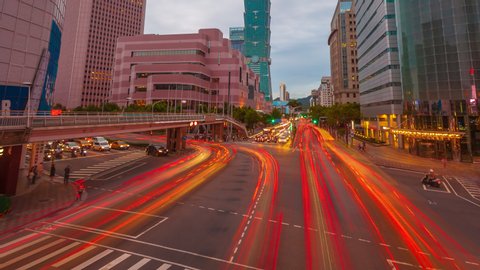 Time lapse of Taipei city skyline and downtown view before sunset overlooking Taipei 101 and Xinyi District busy crossroad with light trails in asia.