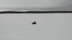 Aerial clip following a snowmobile in Lapland, Finland