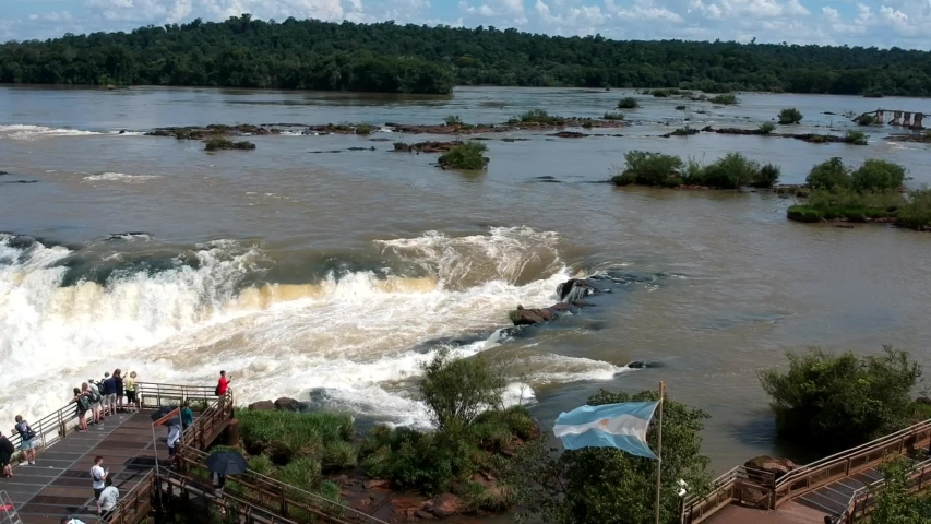 4K aerial view of tourists watching Iguazu falls, Argentina