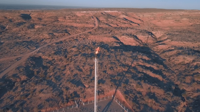 Aerial View of sunset at the pre-oil field whit the gas flare, in the desert