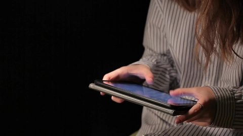 woman shirt tablet dark background