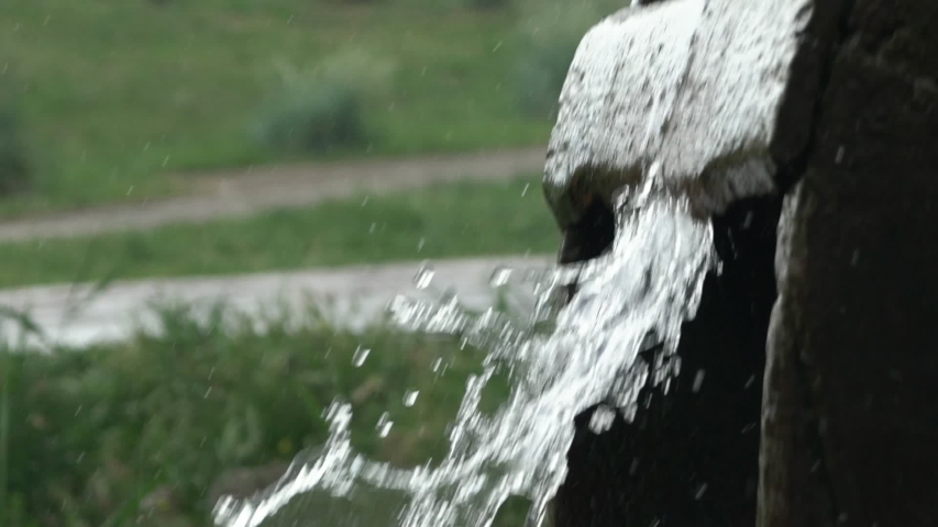 turning wheel of retro water mill in the river splashing water in Slow motion. Close up
