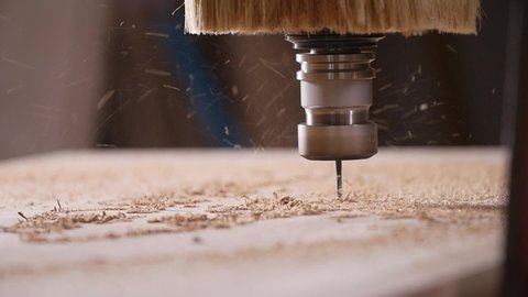 Concept of production and woodworking. Cutting wood with a CNC milling machines