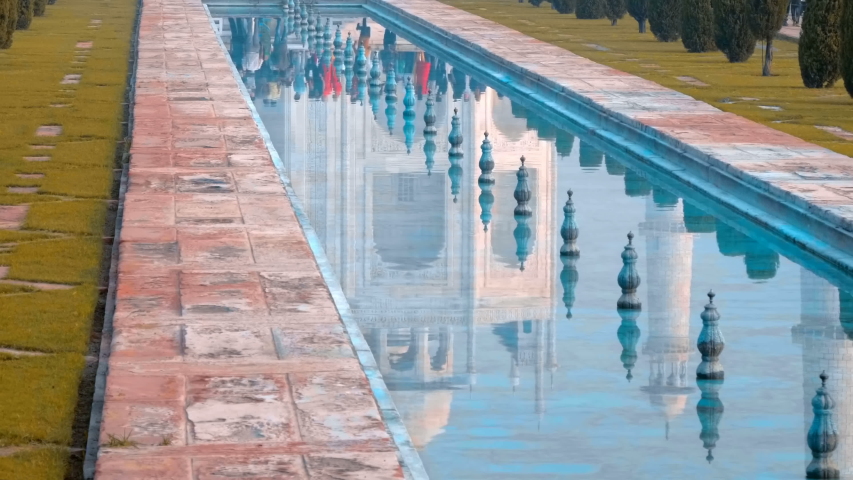 Taj Mahal - a mausoleum mosque, combines elements of Indian, Persian and Arab architectural styles, located in Agra, India, on the banks of the Yamuna River. Reflection from water surface