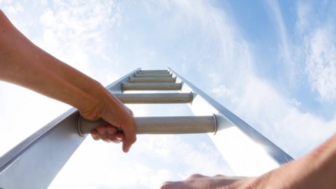 Personal perspective of a caucasian man climbing a ladder 
themes of challenge opportunity motivation win career