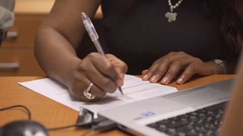 Woman in office desk filling out form