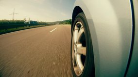 A highly stylized clip of a car speeding down the highway on the German autobahn. Highway wheel strong grade.