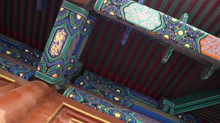 colorful painting of a wooden roof at Temple of Heaven in Beijing China with Visitors