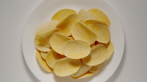 STOP MOTION: Potato chips appear in white plate  