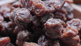 Close up footage of brown raisins. Selective focus. Panning to the left.