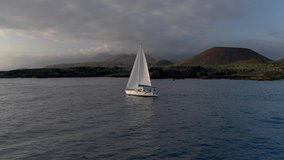 Yacht Sailing Aerial 4k video. Flying drone view of Boat Sailing. Sunset on the Atlantic Ocean. Canary beach paradise island with aqua blue Sky Sea Water