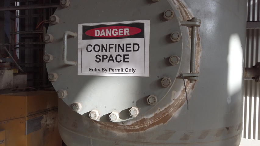A very large confined space at a lead and zinc refinery showing confined space signage and entry points