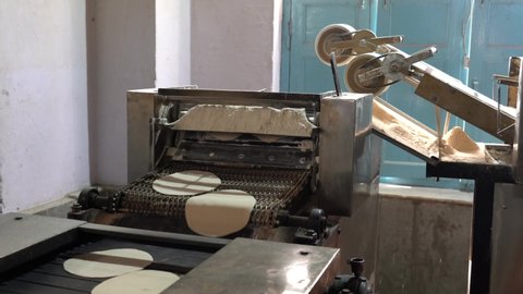 Naan Making Machine - Flattened Dough Runs Down aConveyer Belt  Stock Video