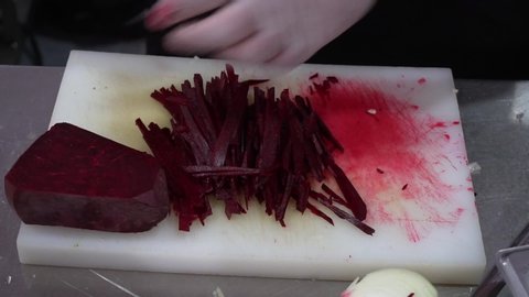 Chef Sliced beet. Preparation Of A Dish Herring Under A Fur Coat.