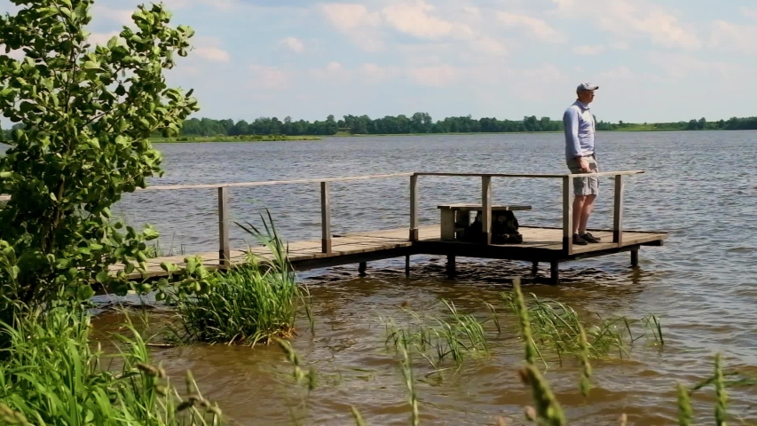 man leaves with a pier at the lake in windy weather