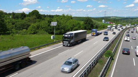 Idstein, Germany - May 29, 2019: Dense traffic and trucks on German highway A3. A3 is a heavily frequented highway that connects the Dutch border with Passau.